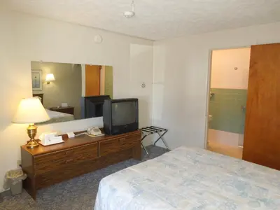 a hotel room with a bed and a television at Arlington Inn in Port Clinton