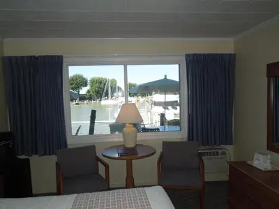 a bedroom with a bed and a window with a view at Arlington Inn in Port Clinton