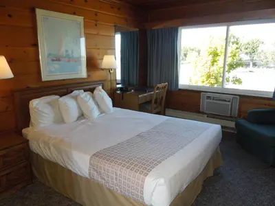 a hotel room with a bed and a window at Arlington Inn in Port Clinton