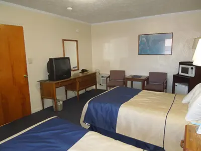 a hotel room with two beds and a television at Arlington Inn in Port Clinton