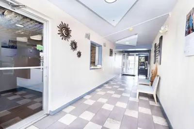 a hallway with a door and a chair in a building at Days Inn by Wyndham Dayton Huber Heights Northeast in Huber Heights