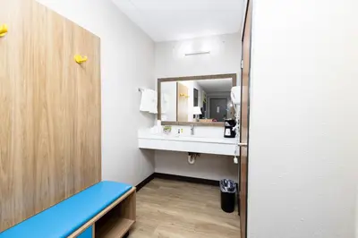 a bathroom with a sink and a mirror at Days Inn by Wyndham Dayton Huber Heights Northeast in Huber Heights