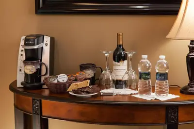 a table with bottles of wine and food on it at The Inn at Honey Run Millersburg in Millersburg
