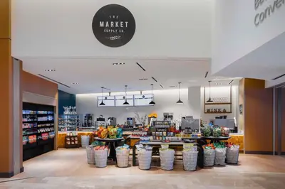 a grocery store with a counter with baskets of produce at Hilton Columbus Downtown in Columbus