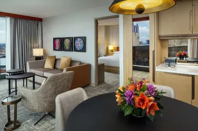 a hotel room with a table with flowers on it at Hilton Columbus Downtown in Columbus