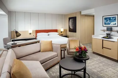 a hotel room with a bed and a living room at Hilton Columbus Downtown in Columbus