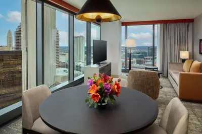 a living room with a table with a vase of flowers at Hilton Columbus Downtown in Columbus