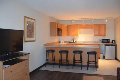 a kitchen with a island with bar stools at Quality Inn Perrysburg - Toledo South in Perrysburg