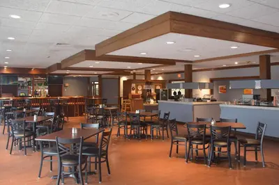 a restaurant with tables and chairs and a bar at Quality Inn Perrysburg - Toledo South in Perrysburg