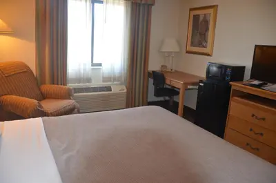 a hotel room with a bed and a desk at Quality Inn Perrysburg - Toledo South in Perrysburg