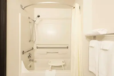 a bathroom with a shower and a toilet in a room at Super 8 by Wyndham Greenfield in Greenfield