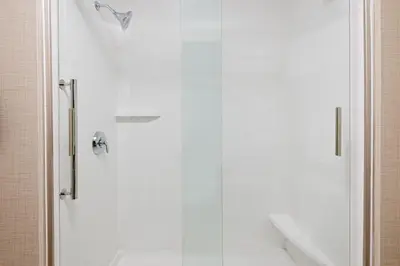 a shower with a glass door in a bathroom at Holiday Inn Express & Suites - Columbus Airport East by IHG in Columbus
