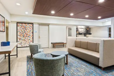 a living room with a couch and chairs at Holiday Inn Express & Suites - Columbus Airport East by IHG in Columbus