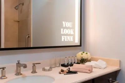 a bathroom counter with a sink and a mirror at Renaissance Toledo Downtown Hotel in Toledo