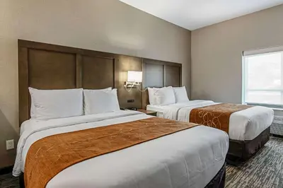 a hotel room with two beds and a window at Comfort Suites Grove City - Columbus South in Grove City