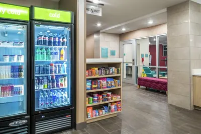 a convenience store aisle with soda machines and drinks at Home2 Suites By Hilton Dayton Centerville in Centerville