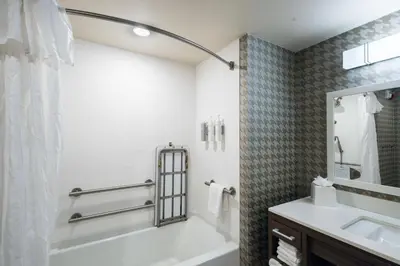 a bathroom with a tub and a sink at Home2 Suites By Hilton Dayton Centerville in Centerville