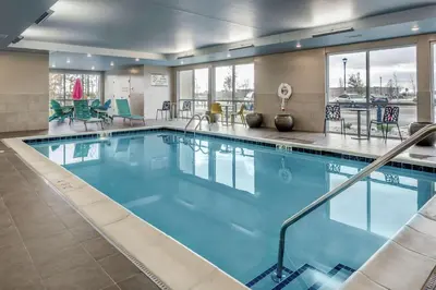 a large pool with blue water in a hotel room at Home2 Suites By Hilton Dayton Centerville in Centerville