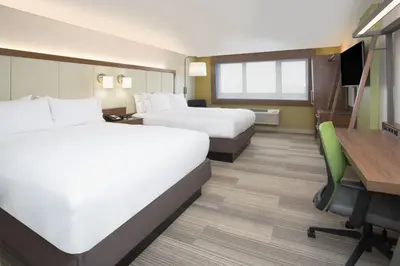 a hotel room with two beds and a desk at Holiday Inn Express & Suites - Millersburg by IHG in Millersburg