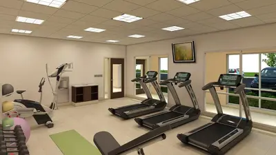 a gym with treadmills and ellipticals in a room at Holiday Inn Express & Suites - Millersburg by IHG in Millersburg