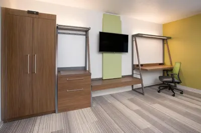 a room with a tv and a desk and a chair at Holiday Inn Express & Suites - Millersburg by IHG in Millersburg