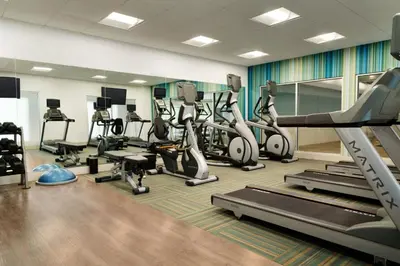 a gym with treadmills and elliptical machines at Holiday Inn Express & Suites - Millersburg by IHG in Millersburg