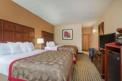 a hotel room with two beds and a flat screen tv at Ramada by Wyndham Columbus North in Westerville