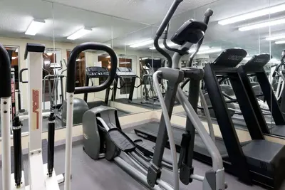 a gym with treadmills and elliptical machines at Baymont by Wyndham Columbus/Rickenbacker in Columbus