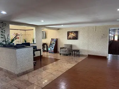 a lobby with a waiting room with a counter and chairs at Quality Inn & Suites Middletown - Franklin in Franklin
