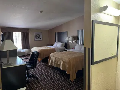 a hotel room with two beds and a desk at Quality Inn & Suites Middletown - Franklin in Franklin