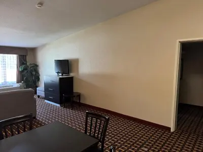 a living room with a couch and a tv on a wall at Quality Inn & Suites Middletown - Franklin in Franklin