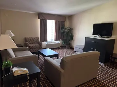 a hotel room with a living room with couches and a television at Quality Inn & Suites Middletown - Franklin in Franklin