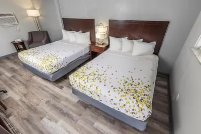 a hotel room with two beds with flowers on them at Butler Inn in Oxford