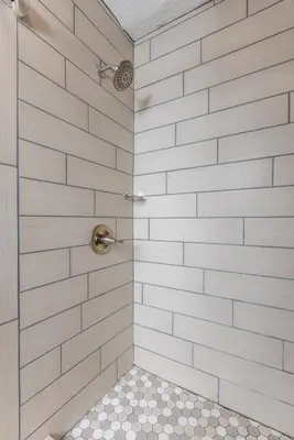 a bathroom with a shower with white subway tiles at Butler Inn in Oxford