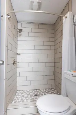 a bathroom with a toilet and a shower at Butler Inn in Oxford