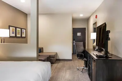 a hotel room with a bed and a desk at Comfort Suites Wooster near University Campus in Wooster