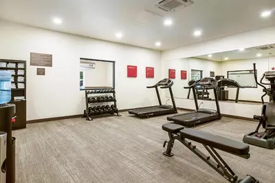 a gym with several tread machines in a room at Comfort Suites Wooster near University Campus in Wooster