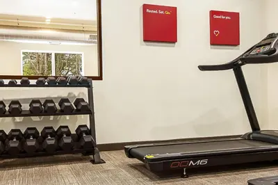 a gym with a treadmill and a rack of shoes at Comfort Suites Wooster near University Campus in Wooster