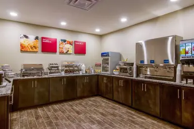 a restaurant kitchen with a counter with food at Comfort Suites Wooster near University Campus in Wooster