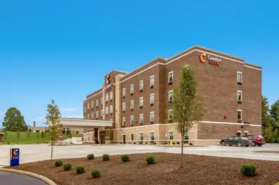 a brick building with a car parked in front of it at Comfort Suites Wooster near University Campus in Wooster