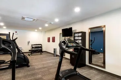 a gym with two tread machines and a mirror at Comfort Suites Brunswick Town Center in Brunswick