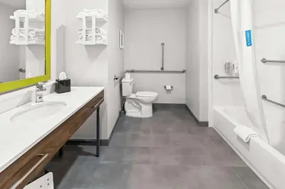 a bathroom with a toilet and a sink and a tub at Hampton Inn by Hilton Dayton South in Miamisburg