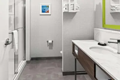 a bathroom with a sink and a shower at Hampton Inn by Hilton Dayton South in Miamisburg