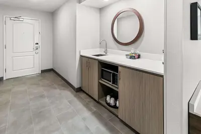 a bathroom with a sink and a mirror at Hampton Inn by Hilton Dayton South in Miamisburg
