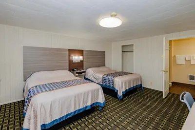 a hotel room with two beds in it at Budget Inn Columbus in Lockbourne
