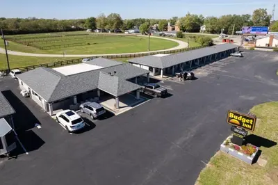 a gas station with cars parked in a parking lot at Budget Inn Columbus in Lockbourne