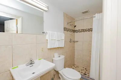 a bathroom with a toilet and a sink and a shower at Budget Inn Columbus in Lockbourne