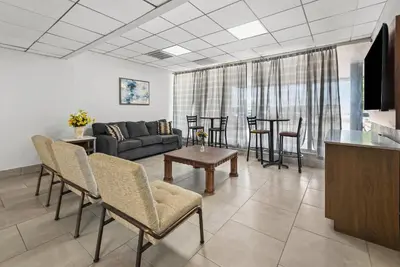 a living room with a couch and a table at Suburban Studios Fairborn - Dayton in Fairborn