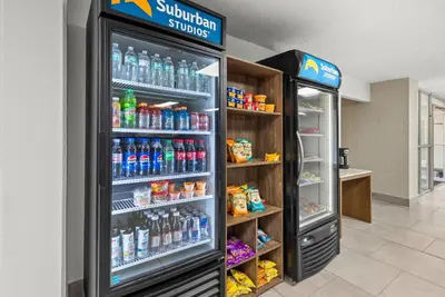a refrigerator filled with lots of drinks in a store at Suburban Studios Fairborn - Dayton in Fairborn