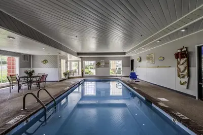a swimming pool in a building with a ceiling at Guesthouse Inn & Suites Lexington in Lexington